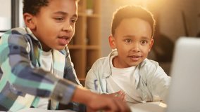 Cute primary school boys kids studying using laptop computer together at home kitchen Adorable african american brothers doing homework writing exercise in notebook indoors Distance online education - Powered by Shutterstock - Get 15% off with code: PIKWIZARD15