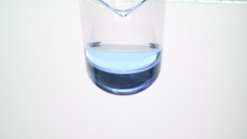 Side view extreme close-up shot of cyan oil is being poured from beaker on grey background | Abstract body care cosmetics ingredients formulating concept Royalty-Free Stock Footage #1100041187