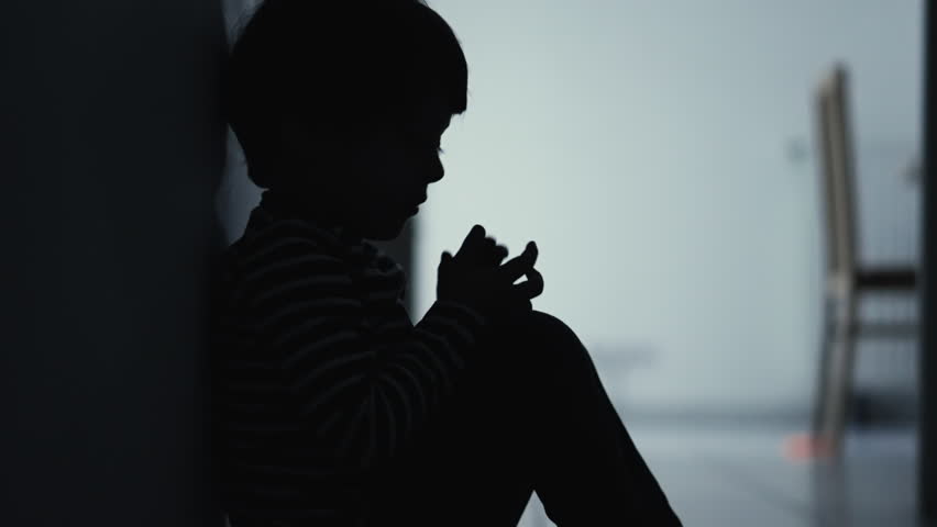 One silhouette of small child suffering feeling despair. Childhood domestic violence concept. Fearful little boy Royalty-Free Stock Footage #1100041637
