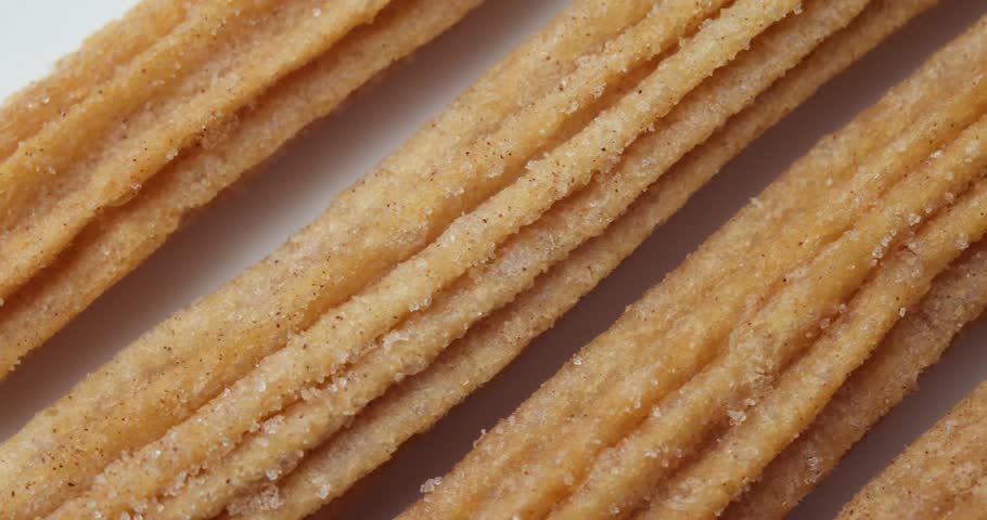 A close up to some Churros while the camera going around. Royalty-Free Stock Footage #1100043943