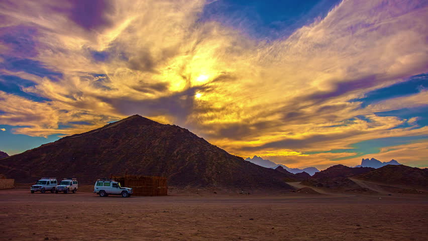 Sunset over a sandstone mountain in the Egyptian desert landscape - time lapse
