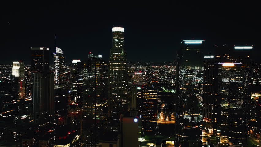 Cinematic Los Angeles Downtown Aerial. Nighttime Aerial Shot of Downtown Los Angeles, Close Fly by Financial District View of DTLA. Famous Skyscrapers At Night, Los Angeles City Hall. United States. 