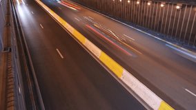 Wide angle 4k time lapse video with rush hour traffic at the entrance of an underground tunnel during the night. Traffic infrastructure video.