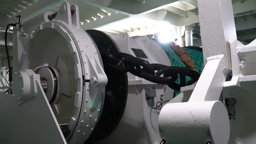 Windlass. Winch winding anchor chain. Anchor chain is wound on drum.