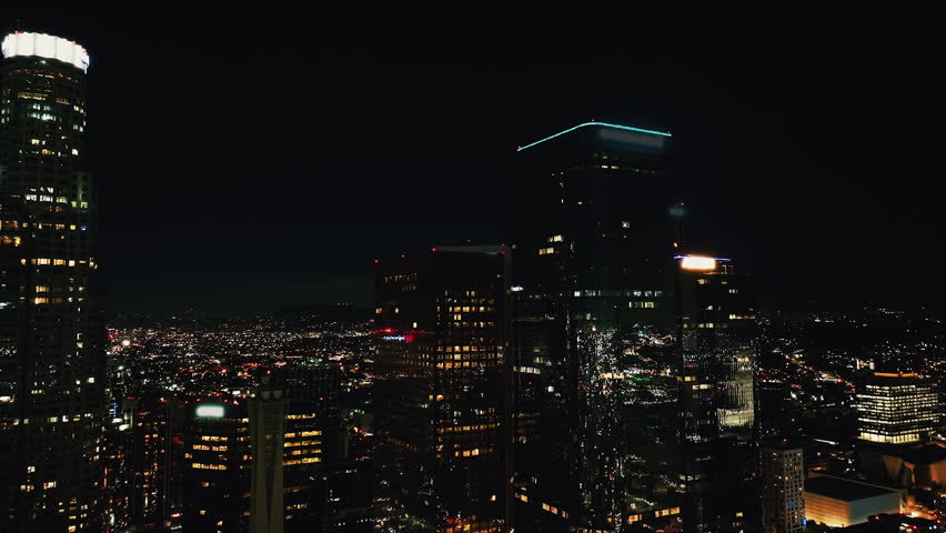 Cinematic Los Angeles Downtown Aerial. Nighttime Aerial Shot of Downtown Los Angeles, Close Fly by Financial District View of DTLA. Famous Skyscrapers At Night, Los Angeles City Hall. United States. 
