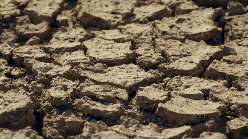 Heavy rain pouring on dry cracked soil, water saving land from drought Royalty-Free Stock Footage #1100050343