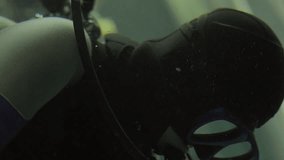 This close up video shows an underwater scuba diver.