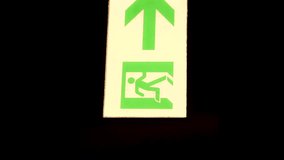 This panning video light up exit sign with an arrow pointing upwards.