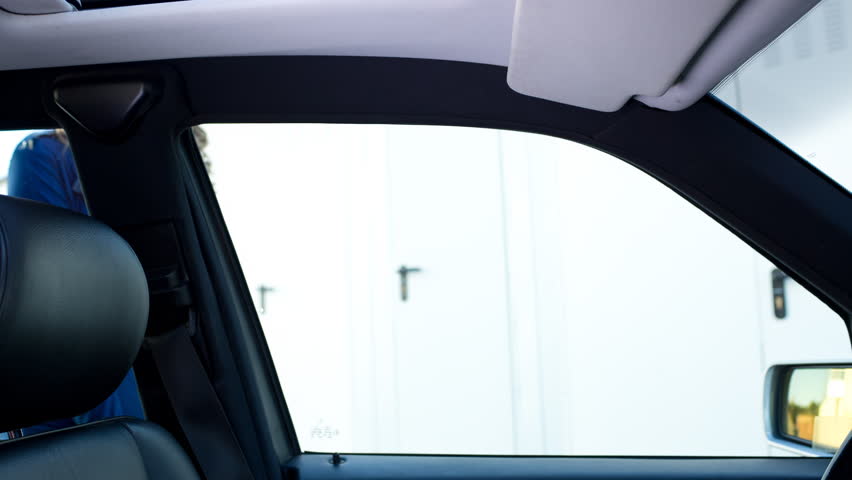 A beautiful female police officer knocks on a car window and starts dancing