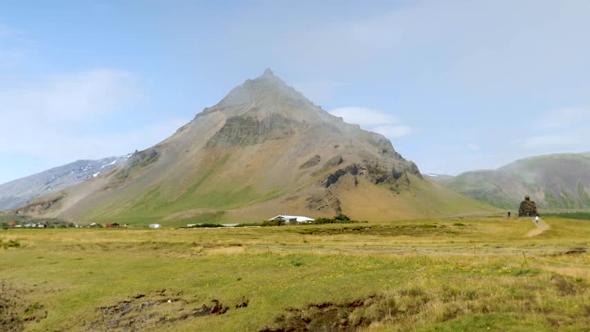 Arnarstapi village in Iceland. Mountains and glaciers in Iceland. Snaefellsjokull in the back. High quality 4k footage. Stapafell mountain and Snaefellsjokull glacier.