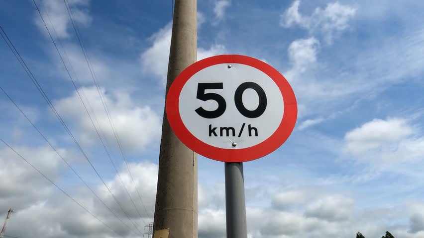 50 km per hour speed limit sign with radar control against car traffic on a city highway Royalty-Free Stock Footage #1100056783