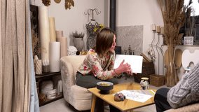 Beautiful female fortune teller reading natal astrology chart male client indoors. Middle-aged woman in casual clothing telling destiny of adult man by analyzing mystery sign symbol. Astrology concept - Powered by Shutterstock - Get 15% off with code: PIKWIZARD15