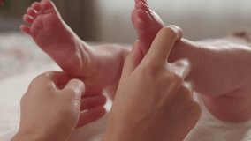 Close up video of Mother making massage to baby foot
