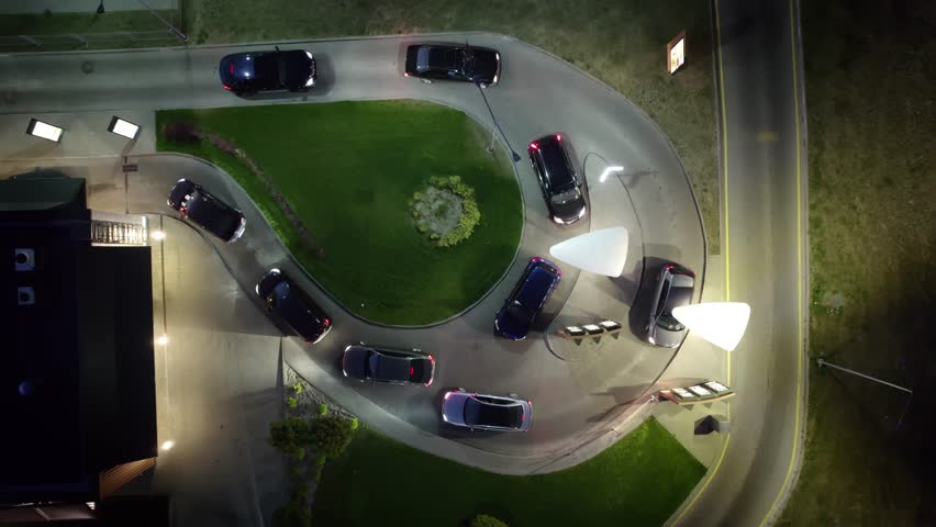 Aerial view of a line of cars queuing at the Drive-through window of a restaurant to pick up their order