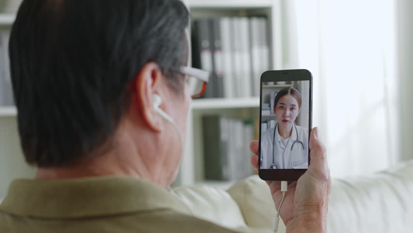 Asian senior man 60s video call via mobile phone with doctor telemedicine telehealth concept Royalty-Free Stock Footage #1100063311
