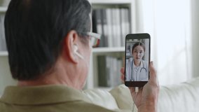 Asian senior man 60s video call via mobile phone with doctor telemedicine telehealth concept