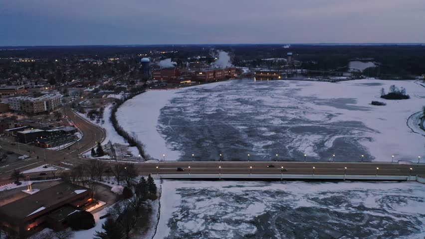 Aerial, Stevens Point during winter, frozen Wisconsin River in the evening
