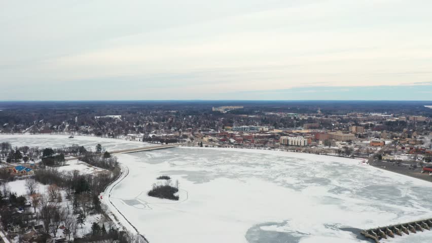Aerial, frozen Wisconsin River during winter season in downtown Stevens Point