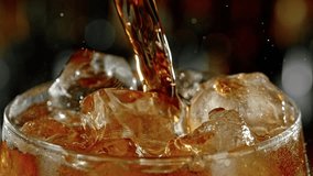 Super slow motion of pouring cola into glass with speed motion. Filmed on high speed cinema camera, 1000 fps. Placed on high speed cine bot. Bar with bottles on background. Speed ramp effect. - Powered by Shutterstock - Get 15% off with code: PIKWIZARD15