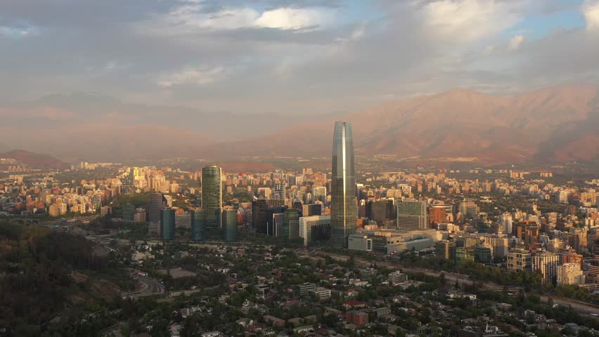 Santiago City at Sunset and Andes Mountains. Aerial View. Chile. Orbiting