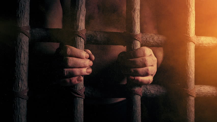 Prisoner Holds Bars In Dusty Sunlight | Shutterstock HD Video #1100073219