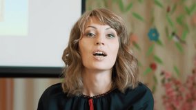 Storytime. portrait shooting. Female teacher, dressed in national traditional clothes, tells something to children's audience in a spacious bright room. - Powered by Shutterstock - Get 15% off with code: PIKWIZARD15