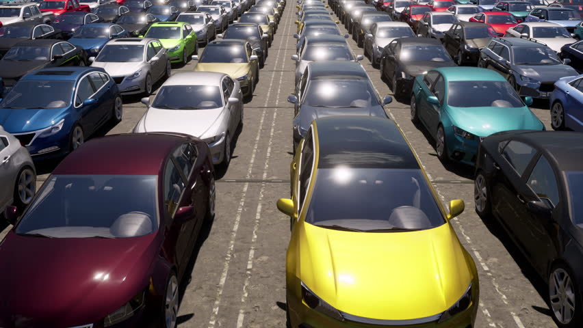 An aerial view over a used car lot full of unsold cars and vehicles. Royalty-Free Stock Footage #1100074519