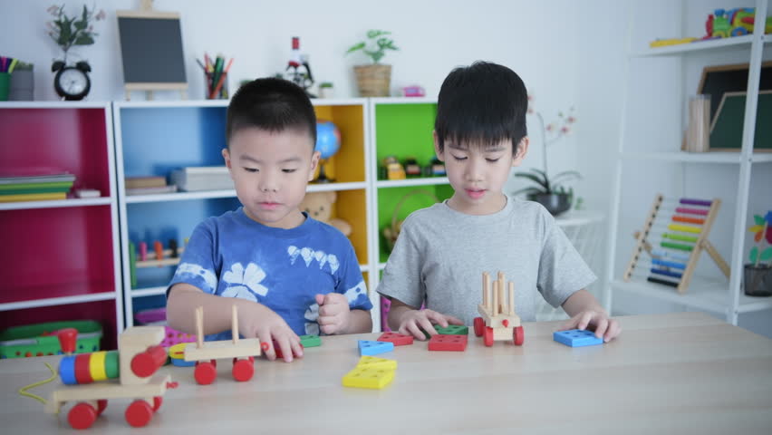 Educational concept of 4k Resolution. Asian kindergarten children are playing with toys together in the classroom.