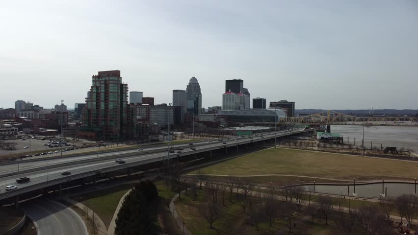Highway traffic flow between Louisville, KY skyline and Waterfront park next to Kentucky river