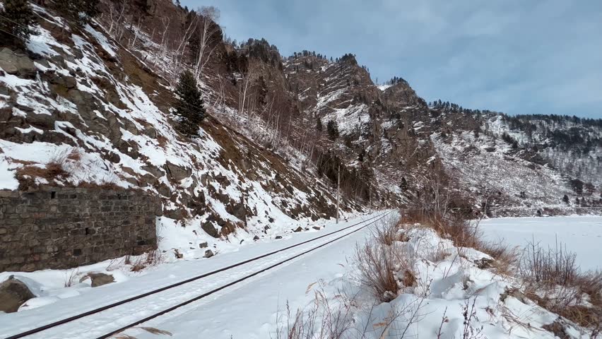 Tunnels and bridges winter circum-Baikal railway at the foot of the mountains on the coast of Lake Baikal, Siberia, Russia. High qualty 4k footage