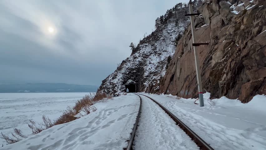 Tunnels and bridges winter circum-Baikal railway at the foot of the mountains on the coast of Lake Baikal, Siberia, Russia. High qualty 4k footage