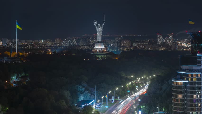 Night vew time lapse of Kyiv, Kiev skyline, cityscape. Motherland Monument. Moonrise.