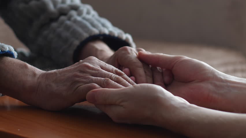 Hands of adult son and elderly father shaking hands. son takes care of old parents. the concept of father's day, family relationships, love for the father, the son hugs the palm of the old father | Shutterstock HD Video #1100081735