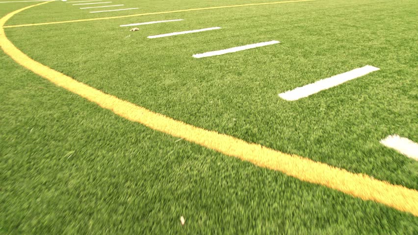 Sport games field grass view. Football field with green grass and white paint lines and marks. Sports soccer and football with nice green environment. Recreational activity ground. Royalty-Free Stock Footage #1100082945
