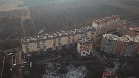 a view from a height from a quadrocopter drone to the new buildings of a new city building. Apartment buildings, streets, city, architecture. high quality bitrate 4k footage