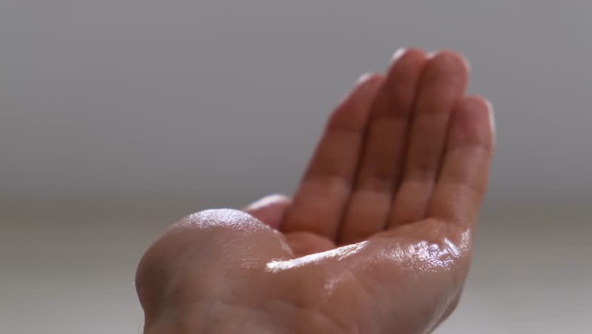 A man pours shampoo into his palm, close-up, slow motion Royalty-Free Stock Footage #1100083169