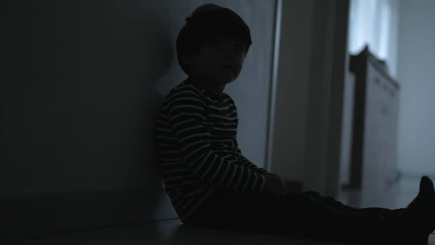 Sad child suffering from childhood depression at home. Psychological trauma concept. One small boy covering face in crisis | Shutterstock HD Video #1100085047