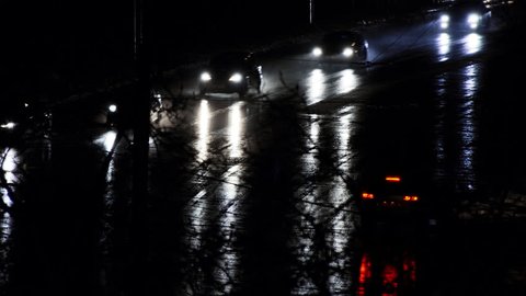 Late night drive through city with reflections of headlights