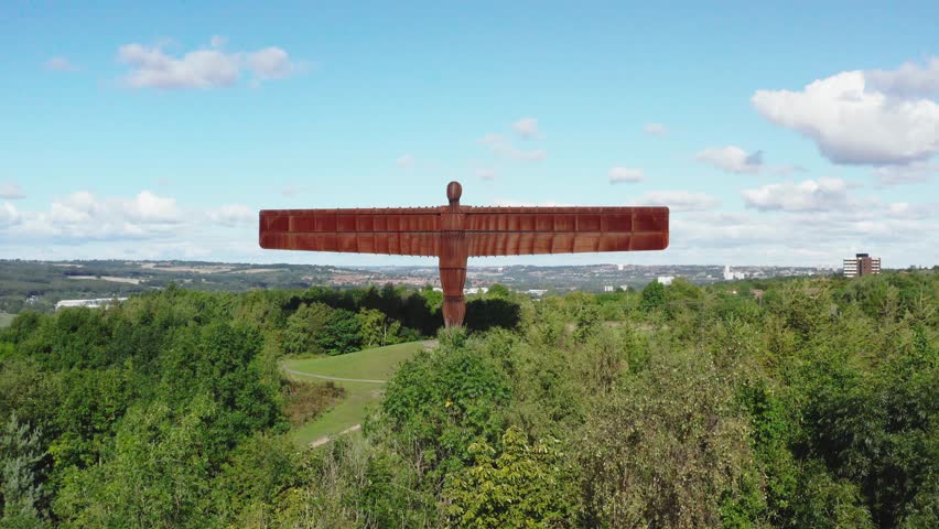 Drone flying over trees towards the Angel of the North at Gateshead near Newcastle England Royalty-Free Stock Footage #1100086101