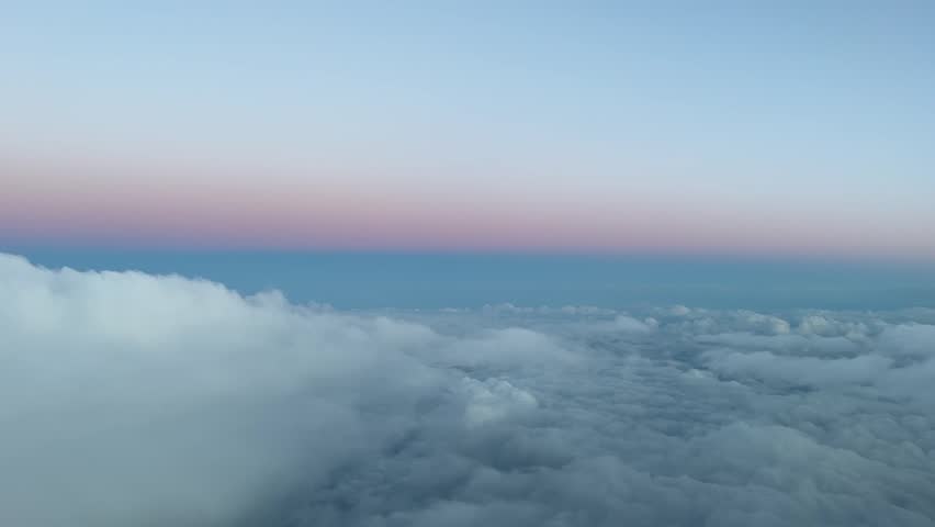 Winter sky view from a jet cockpit descending to Ibiza’s airport, Spain, during the sunset. Pastel colors. Pilot point of view. Royalty-Free Stock Footage #1100087213