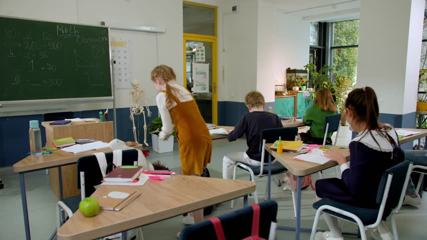 Elementary school class children communicate with the teacher answering question | Shutterstock HD Video #1100092481