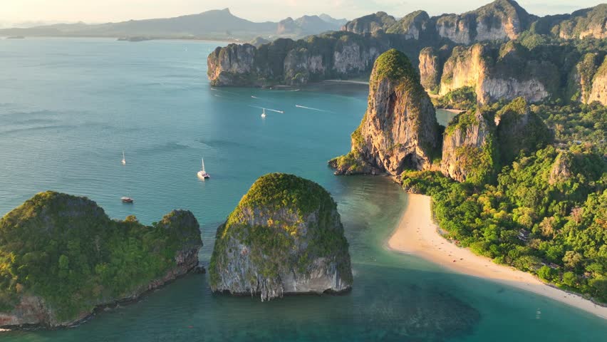 Aerial view of Railay beach at sunset in Thailand, paradise beach in Andaman sea, exotic Thai coastline in Krabi, idyllic Ao nang beach with scenic lagoon in Krabi Royalty-Free Stock Footage #1100094293
