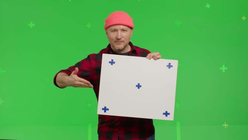 Close-up of portrait of a caucasian man holding a rectangular poster with markers on a Green Screen, Chroma Key. 4k UHD front view isolated video Royalty-Free Stock Footage #1100100271
