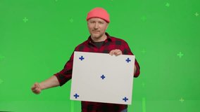 Close-up of portrait of a caucasian man holding a rectangular poster with markers on a Green Screen, Chroma Key. 4k UHD front view isolated video - Powered by Shutterstock - Get 15% off with code: PIKWIZARD15
