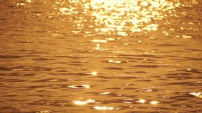 Blurred golden sea at sunset. The sun reflects and sparkles on the waves with bokeh, illuminating the golden sea. Holiday recreation concept. Abstract nautical summer ocean sunset nature background. - Powered by Shutterstock - Get 15% off with code: PIKWIZARD15