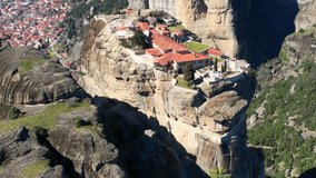 Aerial video of Agia triada , Holy Trinity monastery, an unesco world heritage site,  located on a unique rock formation  above the village of Kalambaka during fall season.