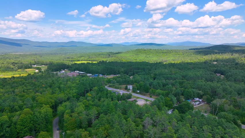 Aerial view the Plymouth rural landscape near Tenney Mountain in summer with White Mountain National Forest at the background in town of Plymouth, New Hampshire NH, USA. 