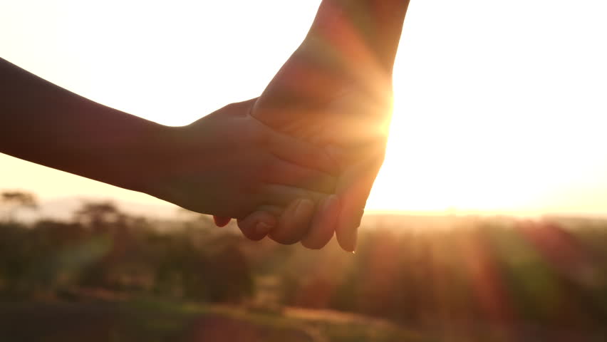 Close-up of a mother and her young daughter holding hands with a sun flare in the background, 4K. Mom and daughter share a sweet moment. Happy Family, Love, and Valentine's Day as an Idea | Shutterstock HD Video #1100107655