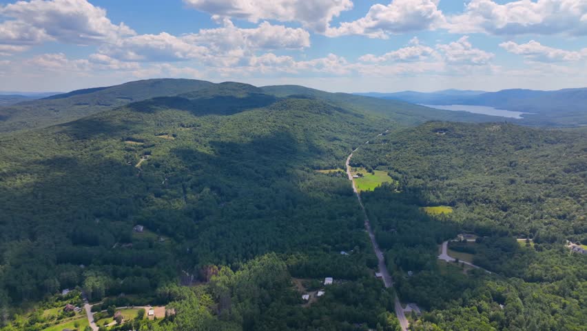 Tenney Mountain Ski Resort with Plymouth rural landscape in summer with White Mountain National Forest at the background in town of Plymouth, New Hampshire NH, USA. 