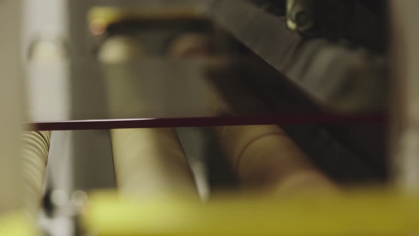 The glass goes into the machine on rollers and goes through the tempering process | Shutterstock HD Video #1100112187